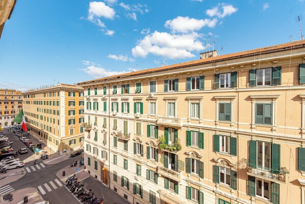 A multi-story building with balconies, a street in front, and a clear sky. - Crescenzio 74 Boutique Guest House by Ghor (Rome)