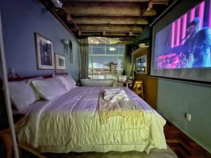 A bedroom with a bed, a television, and a window. - 2002B (São Paulo)