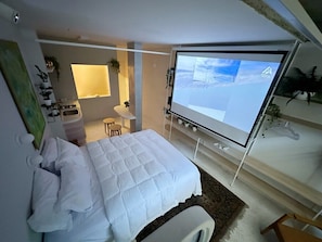 A modern bedroom with a bed, a desk, and a large window. - 2807B (São Paulo)