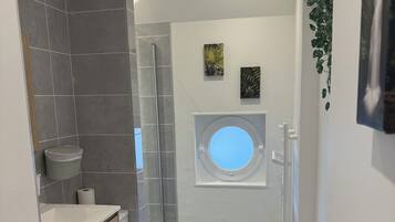 Shower, hair dryer, towels, toilet paper