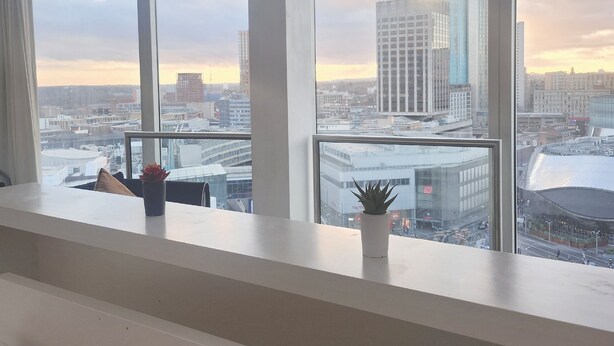 A modern office space with large windows offering a city view. - NewStreet 1Bed Birmingham with Self Checkin (Birmingham)