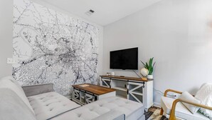 A modern living room with a large map mural, a sofa, a coffee table, a TV, and a side table with a globe. - `Amazing value, convenient location!` +Free prkng! (Nashville)