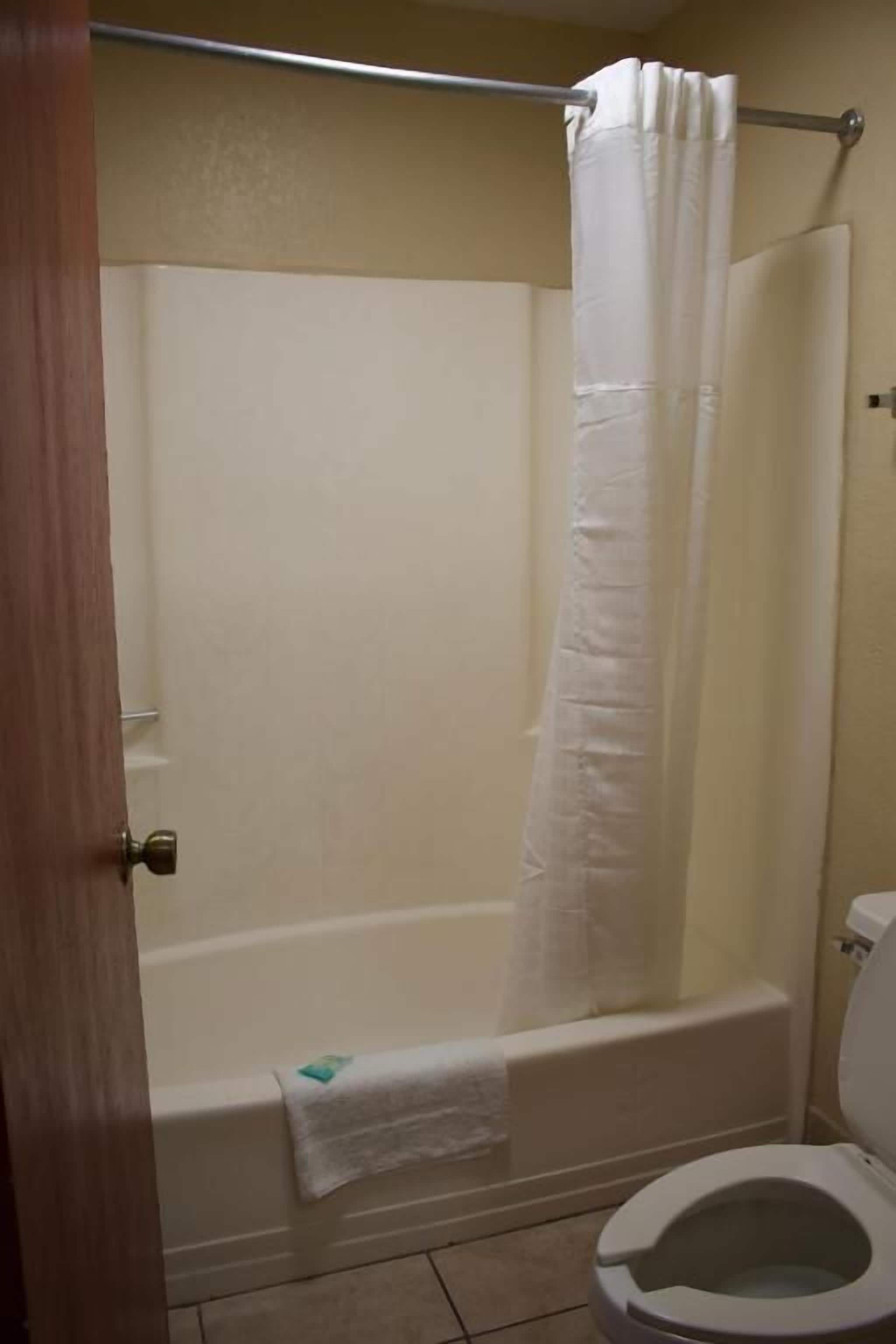 Bathtub, towels, soap, toilet paper