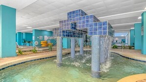 A pool area with a blue-tiled structure and clear water. - Landmark Resort - 747 (Myrtle Beach)