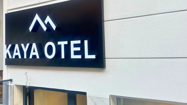 A sign for KAYA HOTEL with a modern design.