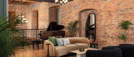 A spacious living area with a brick wall, a grand piano, a sofa, and a coffee table.
