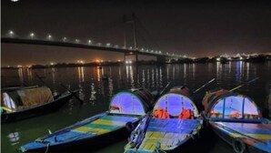 A nighttime view of a river with boats docked along the shore. - SABA GUEST HOUSE (Kolkata)