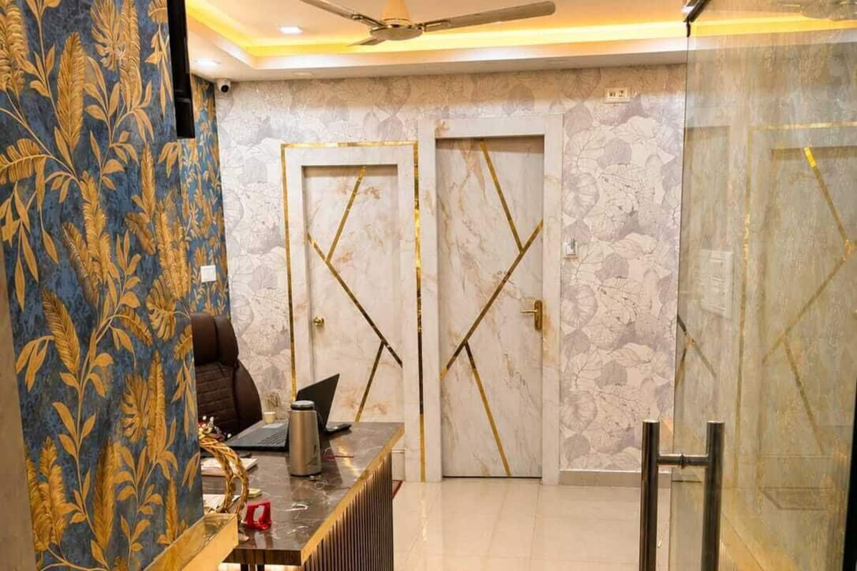 A reception area with a modern desk, a ceiling fan, and marble walls.