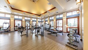 A spacious gym with various exercise machines, large windows, and a wooden floor. - Marriott's Ko Olina Beach Club-Ocean View Studio Unit (kapolei)