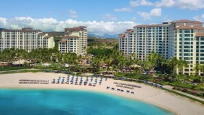 A resort with multiple high-rise buildings, a beach with sun loungers, and a clear blue ocean. - Marriott's Ko Olina Beach Club-Ocean View Studio Unit (kapolei)