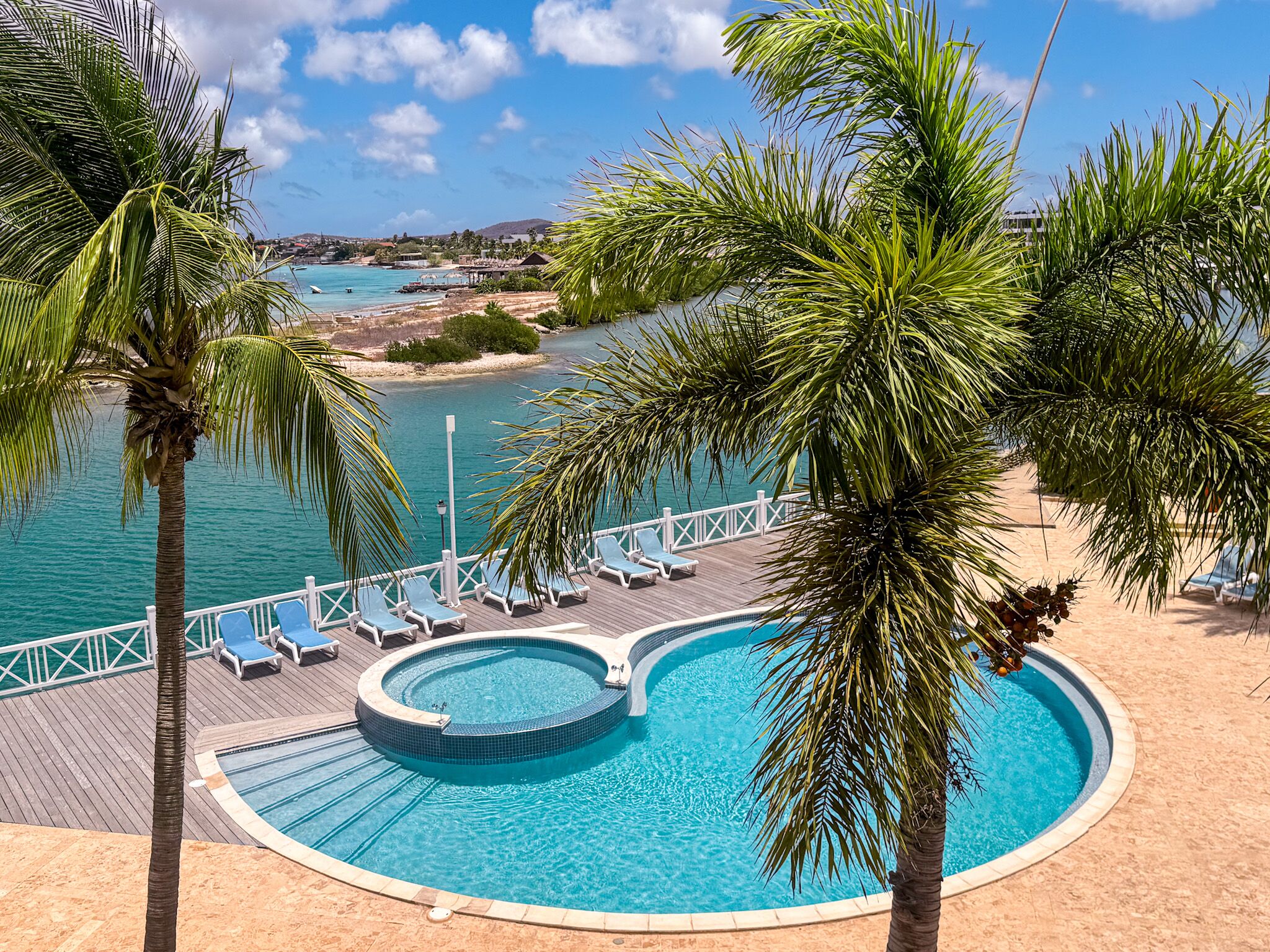 From the balcony, take in the serene pool area below.