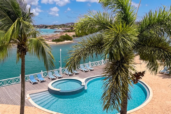 From the balcony, take in the serene pool area below.