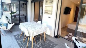 A modern interior with a dining area, a sofa, and a white furry rug. - A haven of peace in Dar Bouazza (Casablanca)