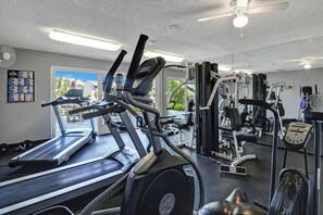 A gym with treadmills, weight machines, and a fan. - Pet-friendly modern Sandstone Villas bungalow (Palm Springs)