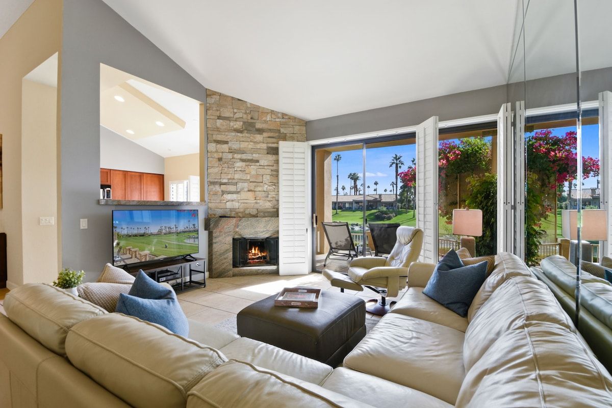 Sink into plush seating and let the warmth of the fireplace embrace you. Your private patio opens to lush greenery, while natural light floods this inviting living space—a perfect retreat after exploring.