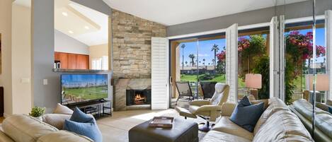 Sink into plush seating and let the warmth of the fireplace embrace you. Your private patio opens to lush greenery, while natural light floods this inviting living space—a perfect retreat after exploring.