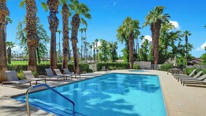 A rectangular swimming pool with a blue border, surrounded by lounge chairs and palm trees. - Spacious-Dogs Ok-Great Views-VB887 (Palm Desert)