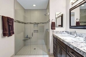Refresh in your spacious private bathroom, featuring a large walk-in shower with glass enclosure, elegant granite countertops, and plush towels waiting for you. - Spacious-Dogs Ok-Great Views-VB887 (Palm Desert)