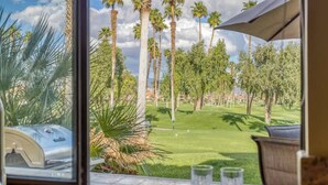 A view of a golf course with palm trees and a clear sky. - Patio-BBQ-4th Green-VB925 (Palm Desert)