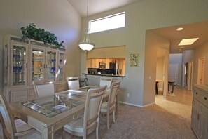 Gather around this elegant dining space, where a glass-top table and custom cabinetry set the stage for memorable meals. High ceilings and natural light create an airy, welcoming ambiance perfect for your getaway. - Large-Spacious-Fitness Room-Close to Pool-V3859 (Palm Desert)