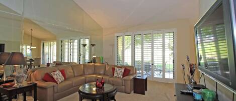 Sink into the plush sectional and let natural light stream through plantation shutters opening to your private patio—your perfect retreat for unwinding after a day of exploring.