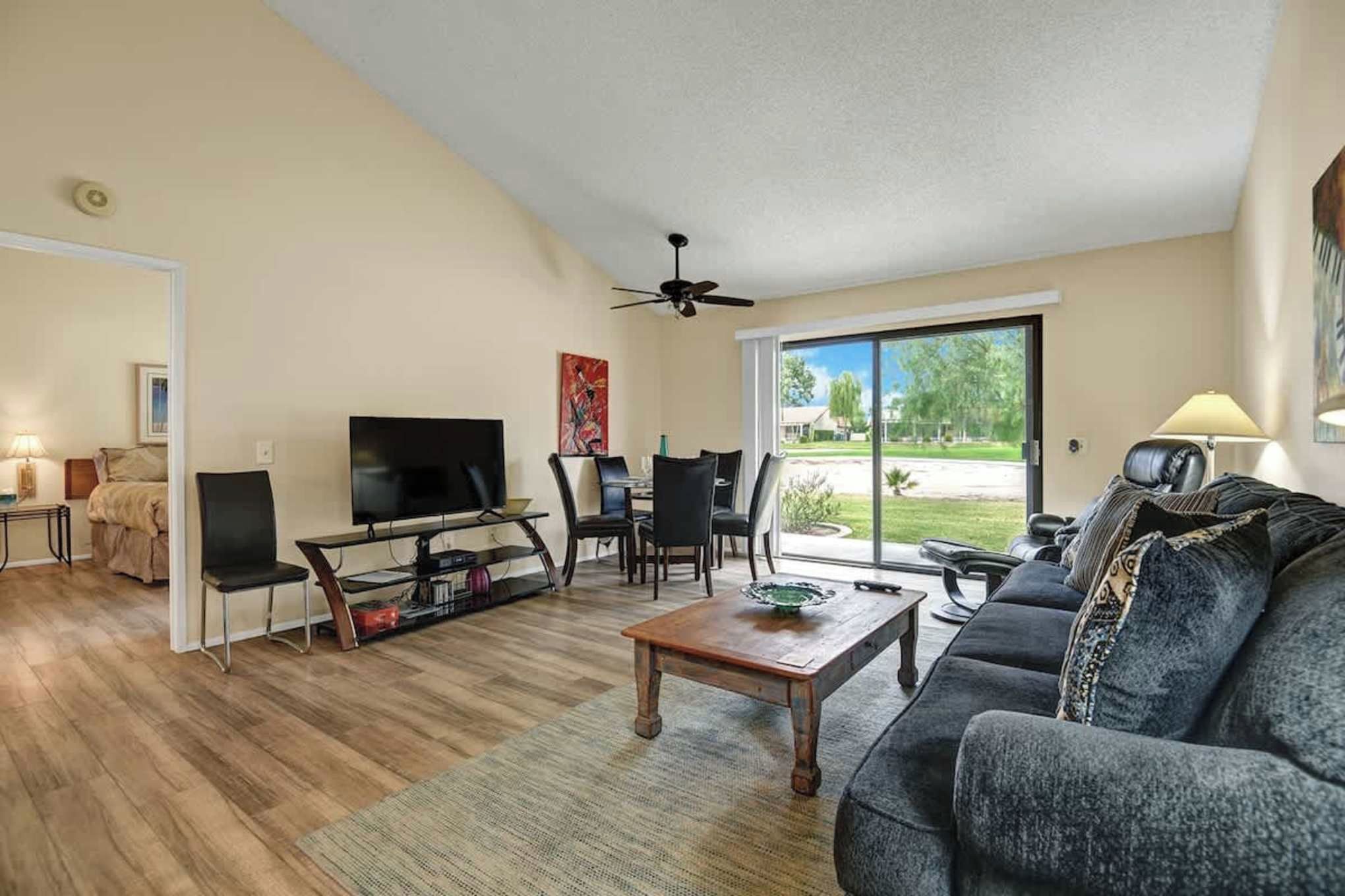 Settle into your spacious living room where natural light pours through the sliding glass doors. Kick back on the plush sofa after a day of exploring, or gather around the dining table for a leisurely meal with your travel companions.