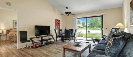 Settle into your spacious living room where natural light pours through the sliding glass doors. Kick back on the plush sofa after a day of exploring, or gather around the dining table for a leisurely meal with your travel companions.