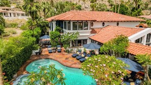 A house with a swimming pool, surrounded by lush greenery and palm trees. - Pet-friendly tennis estate in The Mesa|360-views (Palm Springs)