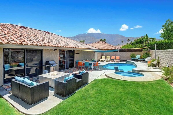 A backyard with a swimming pool, outdoor furniture, and a patio area. - Centrally located pet-friendly home|Pool|Spa (Palm Springs)