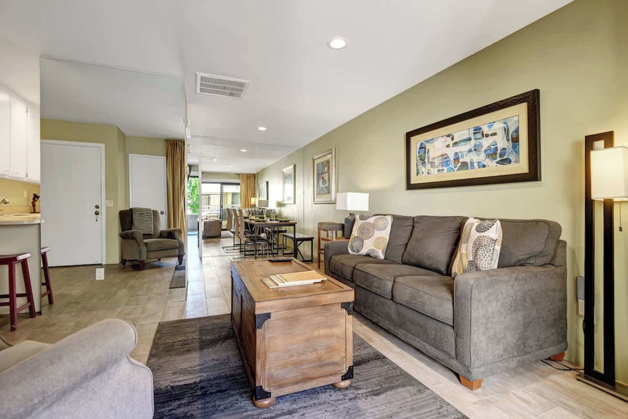 Settle into your spacious open-plan living area where comfort meets style. Relax on the plush sofa, gather around the dining table, or step out to your private patio for fresh air and sunshine.