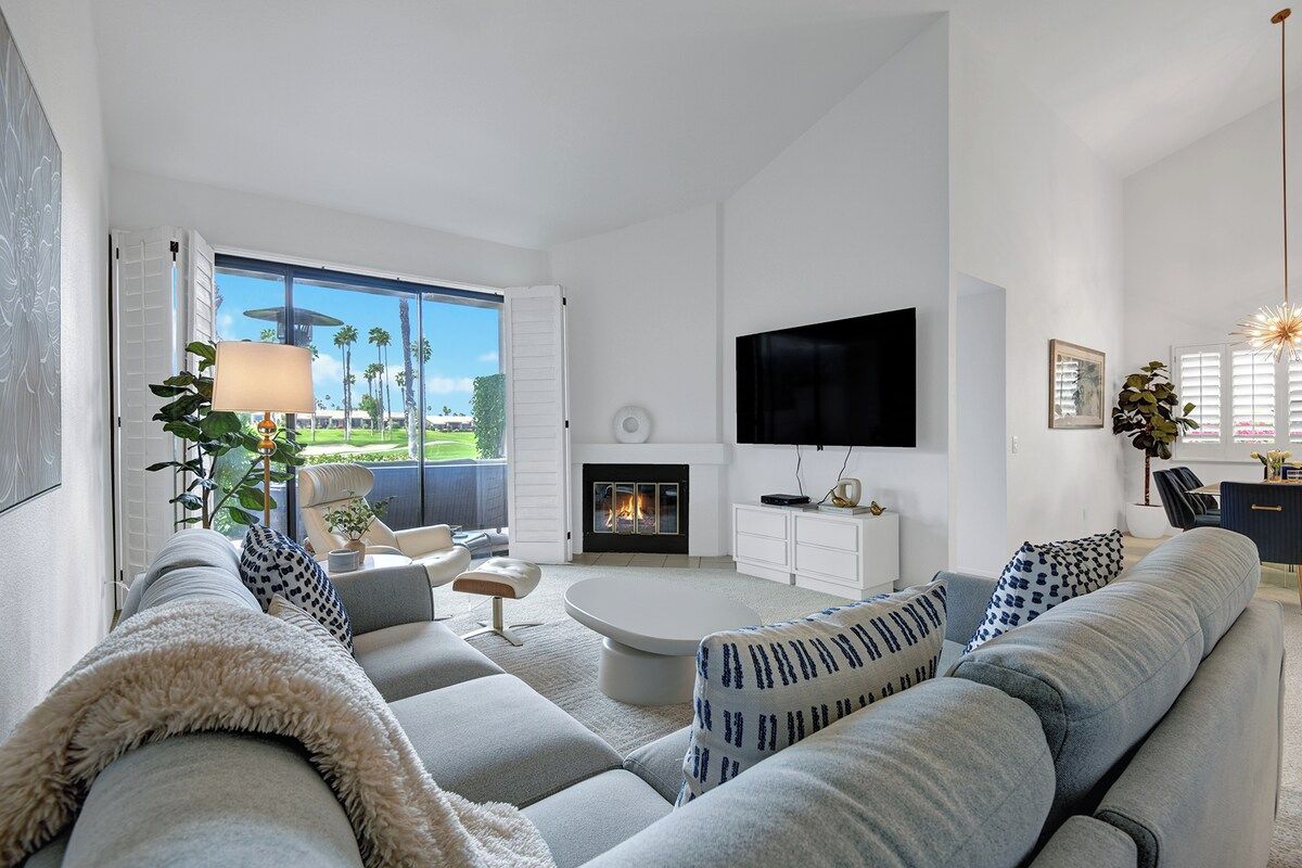 Sink into plush seating in your bright, airy living room where vaulted ceilings and a cozy fireplace create the perfect backdrop for your desert getaway.