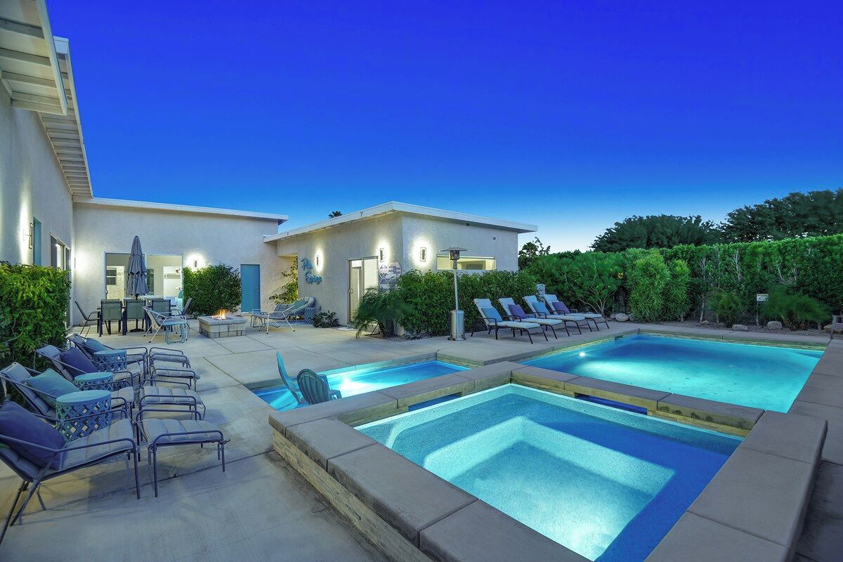 A stunning multi-level pool complex awaits under a brilliant desert sky, with plenty of lounge chairs for soaking up the sun and a separate spa for ultimate relaxation.