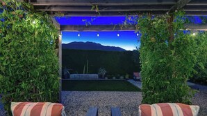 A covered outdoor seating area with a view of a mountain range. - Alejo Olive Orchard- Beautiful 3 Bed Home with Pool/Spa  - 5 minute drive to downtown Palm Springs. (Palm Springs)