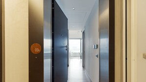 A hallway with a door marked '03b' leading to a bright room with a view. - GuestHost - Cozy Studio in Portello District (Milano)