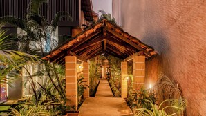 A covered walkway with potted plants, leading to a building entrance. - Pousada St. Ines Boutique Stays (Panaji)