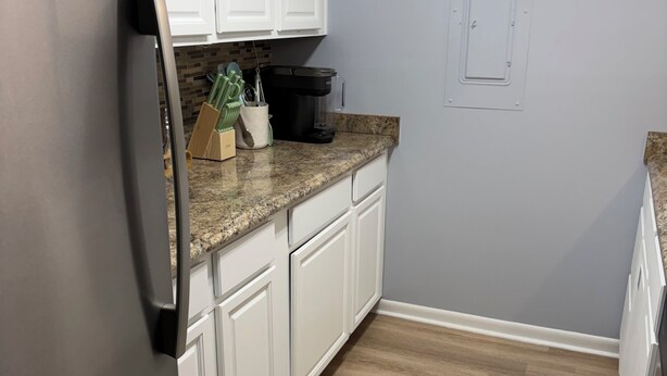 A kitchen with white cabinets, a stainless steel refrigerator, a coffee maker, and a microwave. - 2BR 1B condo Amelia island, 2 blocks beach 2 miles downtown 1 mile Fort Clinch (Fernandina Beach)