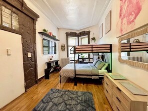 A room with a bunk bed, a desk, a radiator, and a large mirror. - Brooklyn Eco-Luxury Tech Loft - Sleeps 4 + 20Min to Manhattan-1st FL-AC-FASTWIFI (brooklyn)