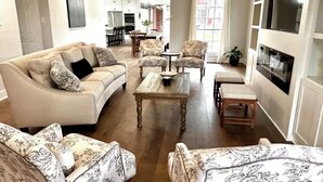 A living room with a sofa, armchairs, a coffee table, and a fireplace. - Beautiful Private 30 Acre Nature Retreat/Pool
Ideal for family/groups sleeps 16 (Plantersville)