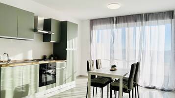 Premium Apartment, City View | Private kitchen | Full-size fridge, oven, stovetop, cookware/dishes/utensils
