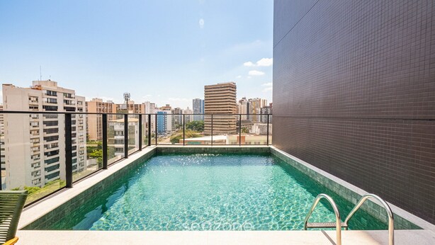 Una piscina en la azotea con vistas a edificios circundantes.