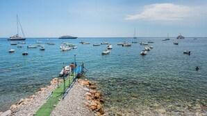 A marina with boats docked and a pier extending into the water. - GuestHost - Cozy 43 sqm ground floor apartment, perfect for three people (accessible via a few steps).The property enjoys a prime location, directly on the beach, with convenient access to the sea. The Taormina - Giardini train station is less than a 10- (Naxos)