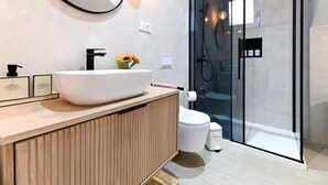 A modern bathroom with a large white sink, a wooden vanity, a glass shower enclosure, and a toilet. - Zadar Apartment Sweet Life - Studio Apartment with Balcony (Zadar)