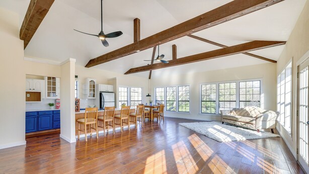 A spacious living area with hardwood flooring, a dining set, and large windows providing natural light. - Quiet & Convenient Unit, 7 Mi to Lake Ray Hubbard! (Sunnyvale)
