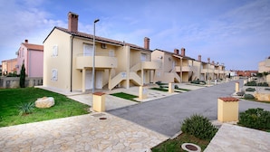 A row of modern, two-story residential buildings with balconies and a central courtyard. - Beautiful apartment in Medulin (Medulin)