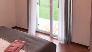 A bedroom with a bed, a window with curtains, and a view of a garden. - 3 bedroom gorgeous apartment in Medulin (Medulin)