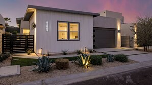 A modern house with a garage, a well-lit front yard, and a number '41843' on the wall. - Brand New! Chic, Gated & Safe. Family & Pet Friendly, Sleeps 9 with Rec. Room… (Indio)