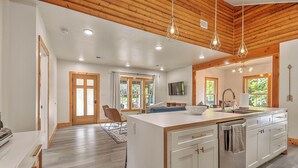 A modern kitchen with a central island, wooden ceiling, and recessed lighting. - Modern 4BD / 4.5BA Home Near ETSU, Mountain Home VA, JCMC, & Downtown JC (Johnson City)