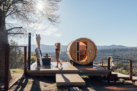 A wooden sauna structure, a wooden deck, and a scenic mountain view.. Mountains & Moon – Wellness Elevated: Pool, Nordic Spa, Private Gym, Views