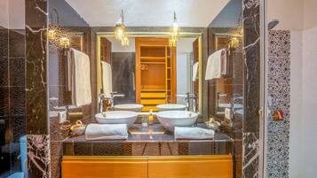 A bathroom with two sinks, a large mirror, and a wooden vanity.