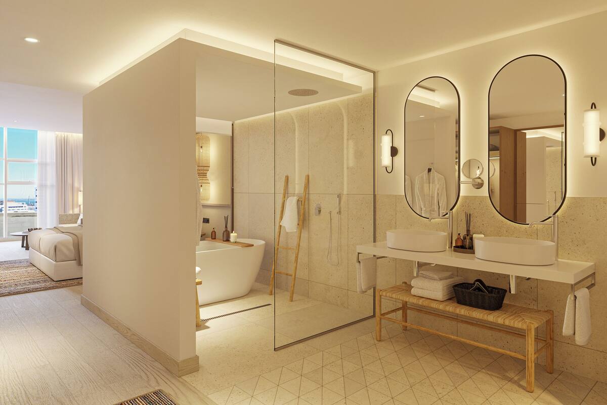 Une salle de bain moderne avec une baignoire, deux lavabos et un grand miroir.